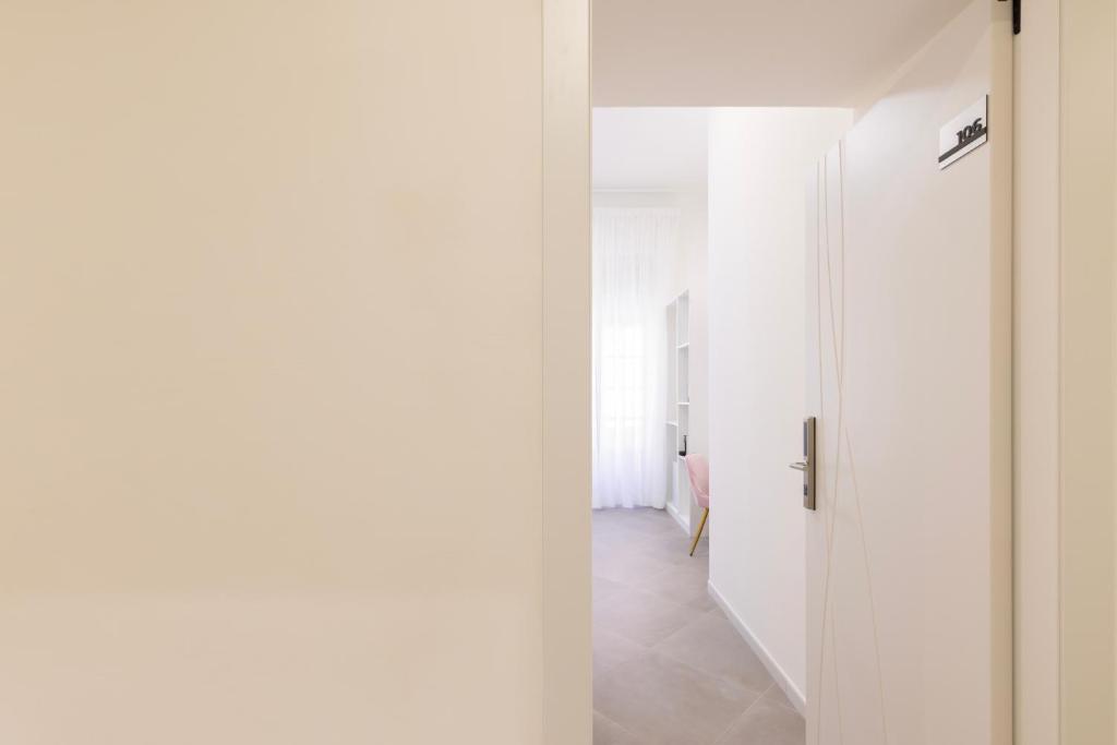 an open door in a room with a hallway at Maddalena Rooms - Eja Sardinia in Cagliari