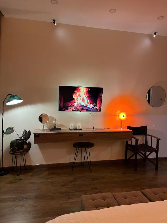 a room with a table with a tv on the wall at Villa Délight House “Stay&Chill” in Da Lat
