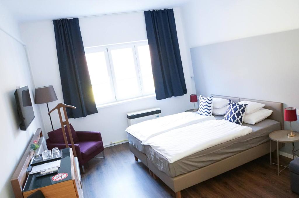Postel nebo postele na pokoji v ubytování Pécs Centrum Apartman
