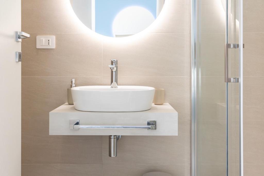 a bathroom with a sink and a shower at Maddalena Rooms - Eja Sardinia in Cagliari