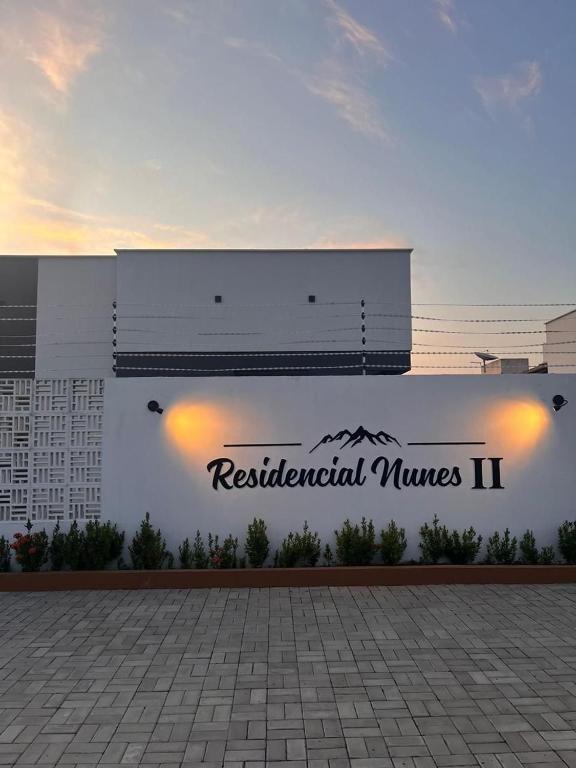 a building with a sign for residentialumes ii at Casa 100% mobiliada no Caçari in Boa Vista