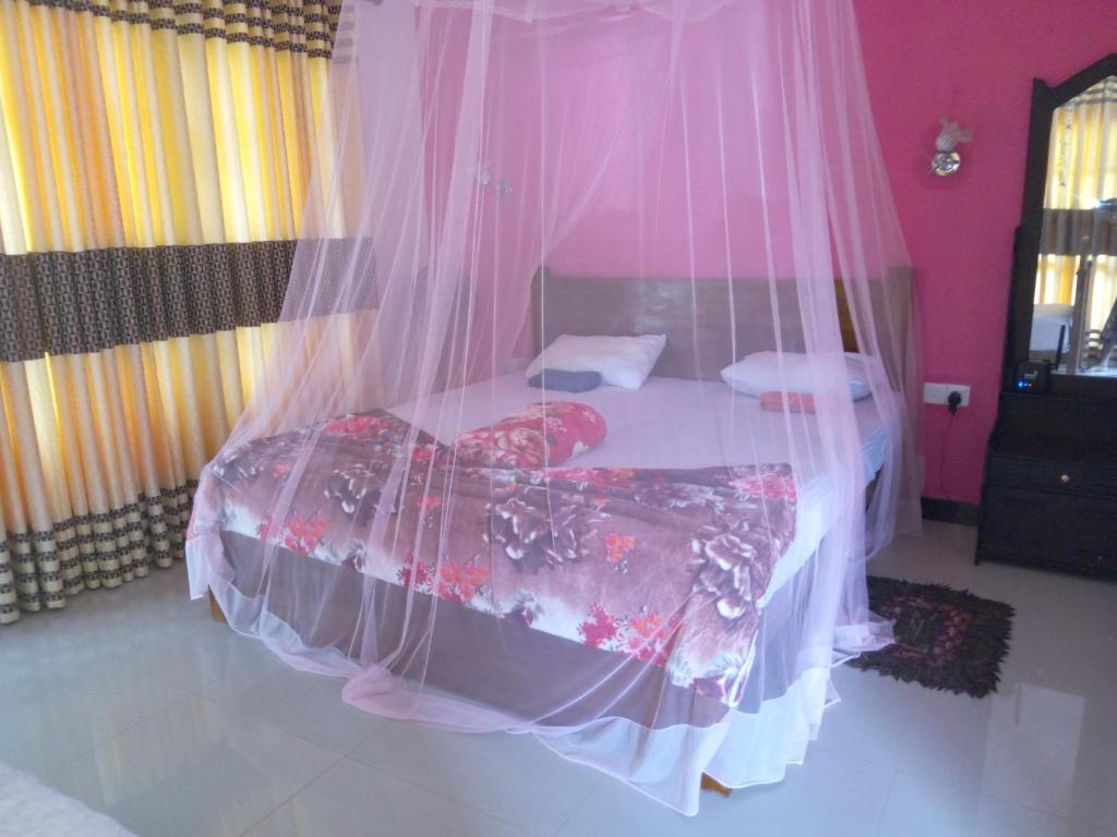 Postel nebo postele na pokoji v ubytování Nine Arch Araliya Homestay