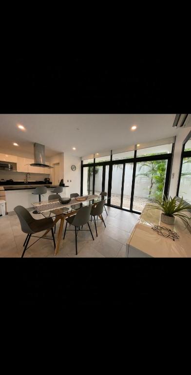 a dining room with a table and chairs in a room at Villa Roma in Akumal