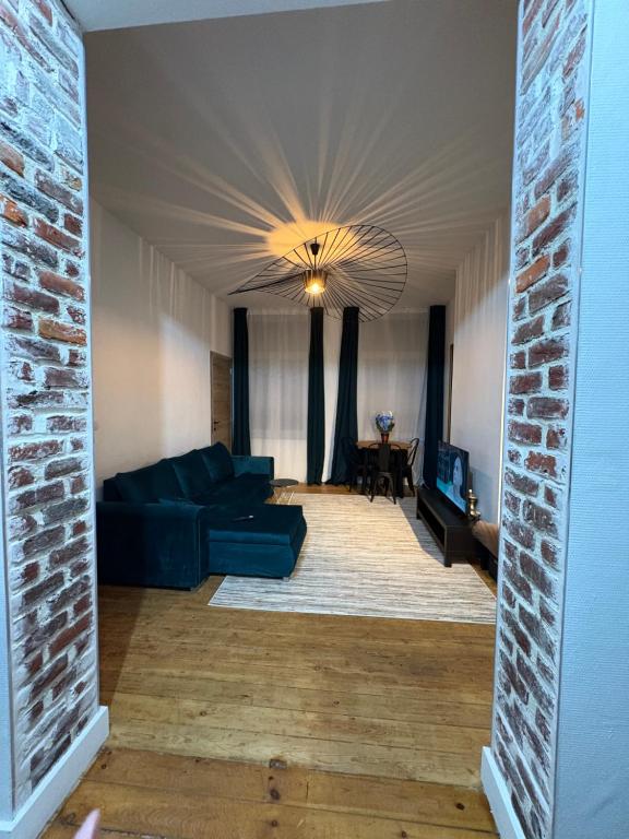 a living room with a couch and a ceiling at Echoes of the Mirror in Brussels