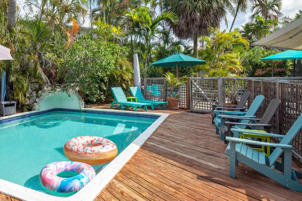 a pool with chairs and a donut in the water at Sunnyside Up in Key West