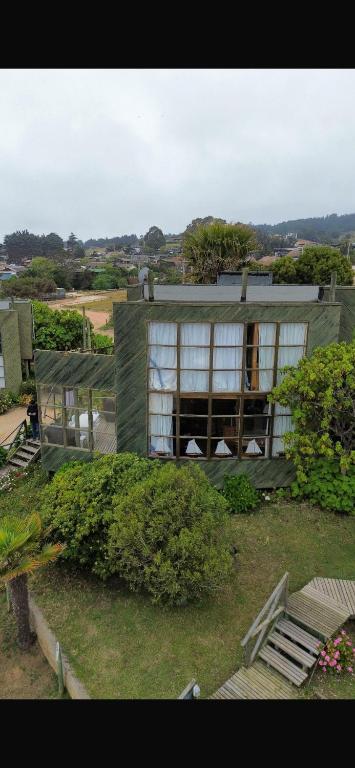 ein Gebäude mit einem großen Fenster im Hof in der Unterkunft cabaña punta de lobos in Pichilemu