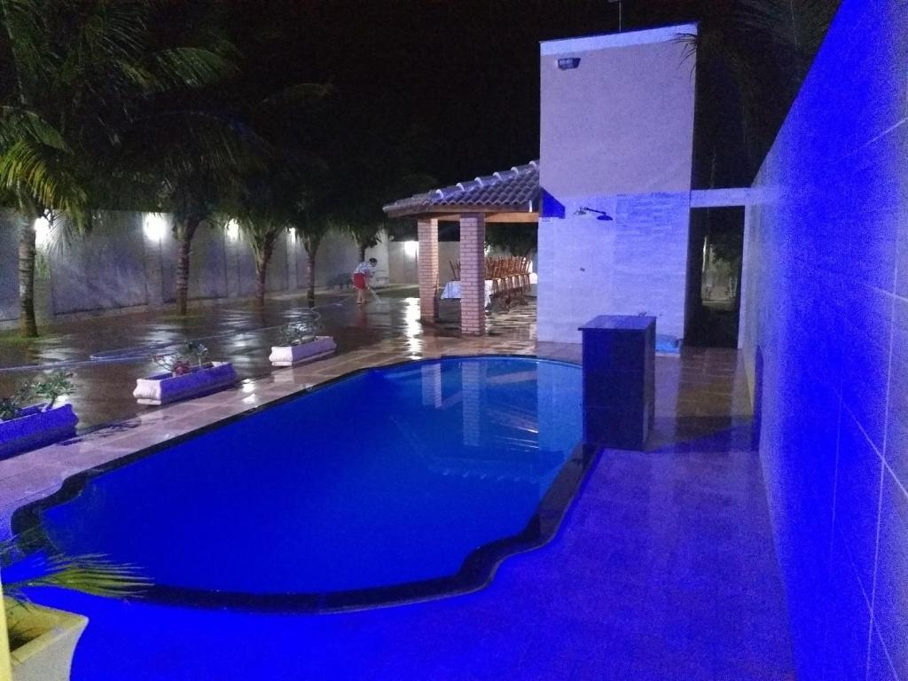 a swimming pool at night with blue lighting at Rancho Costa in Pereira Barreto
