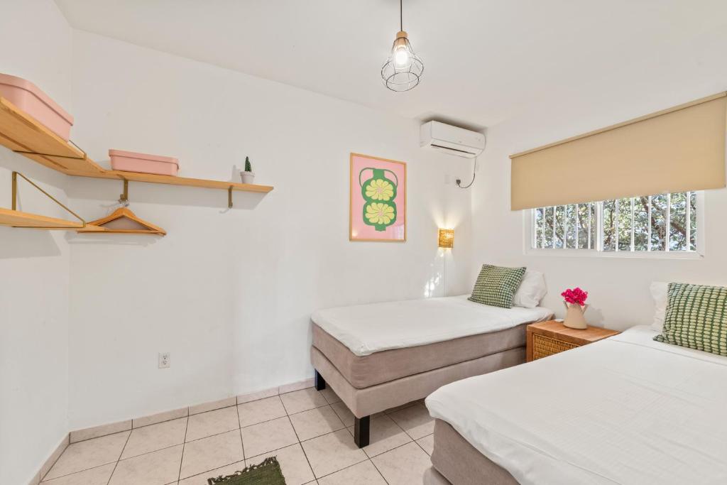 Postel nebo postele na pokoji v ubytování TUK Tropical Boutique Resort Jan Thiel