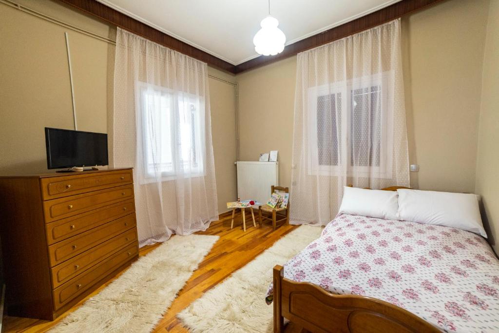 a bedroom with a bed and a dresser and a television at The Lily Nest in Lilí