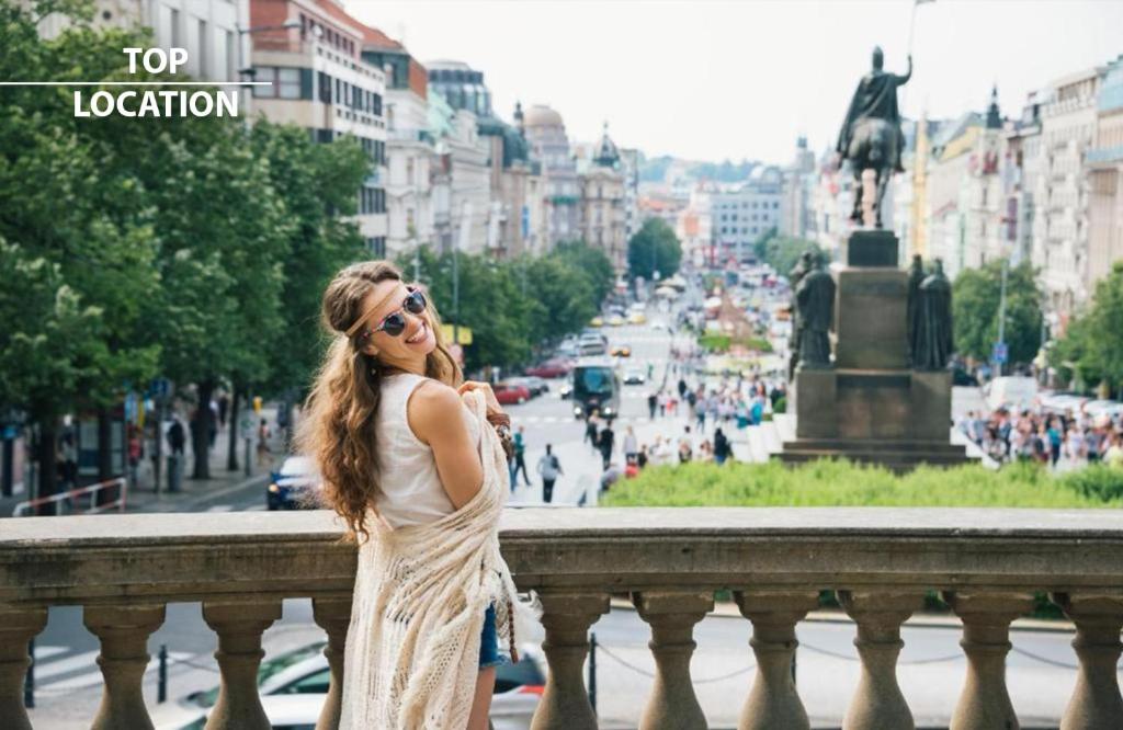 a woman in a white dress standing on a bridge at Wenceslas Square Hotel - Czech Leading Hotels in Prague
