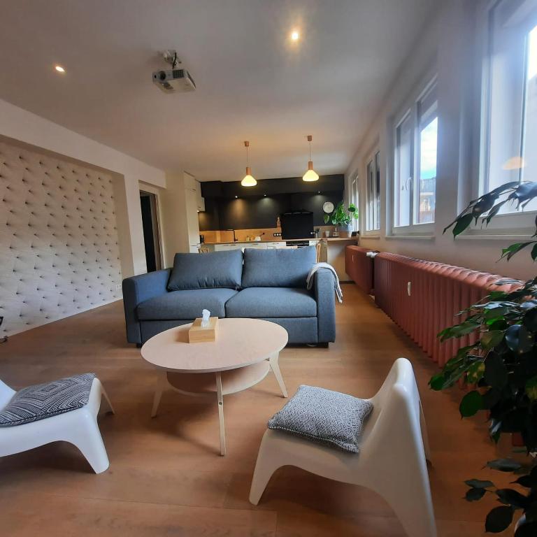 un salon avec un canapé, une table et des chaises dans l'établissement Hyper Centre- Hyper Calme, à Strasbourg