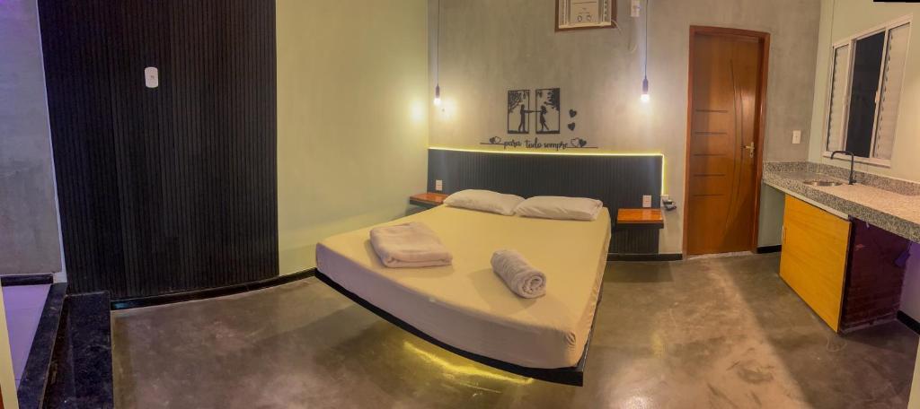 a bedroom with a bed with two towels on it at Bella Ciao Hostel in Rio de Janeiro