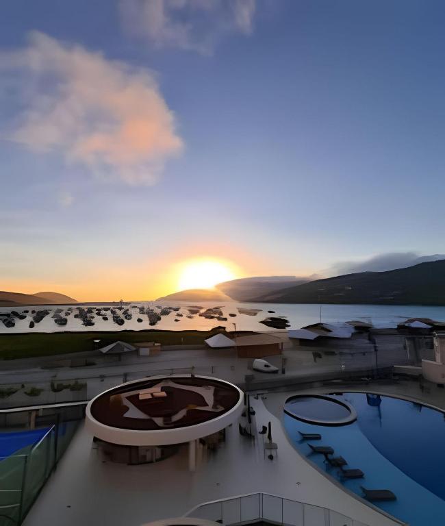 an aerial view of a resort with a sunset at Arraial | Apartamento com 3 suítes e Vista Mar in Arraial do Cabo