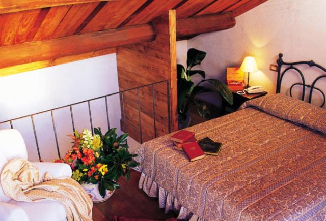 A bed or beds in a room at Hotel La Locanda Dei Ciocca
