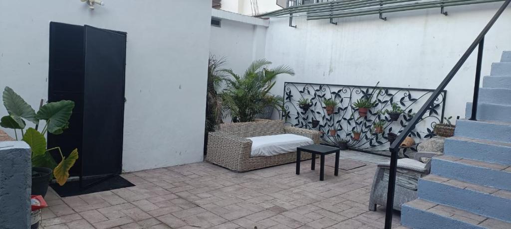 a patio with a couch and some plants and stairs at Dep #1 Basilio in Puerto Vallarta