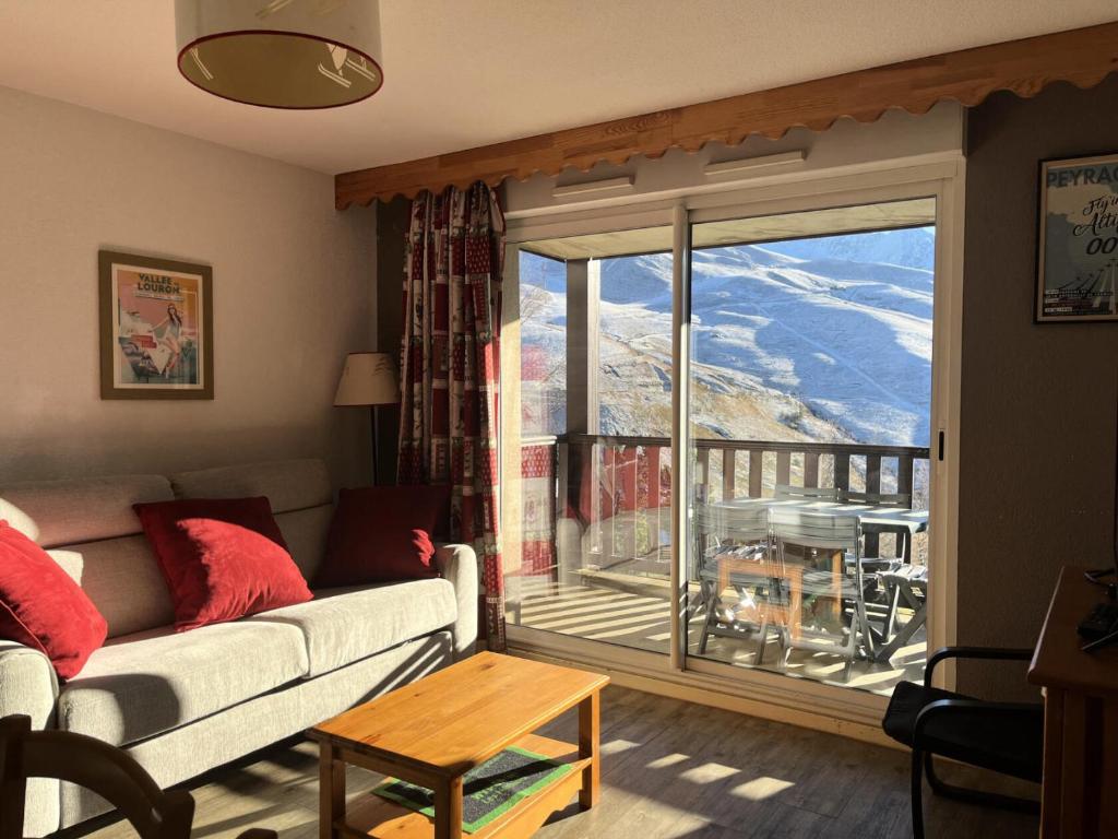 a living room with a couch and a large window at Résidence Hauts De Peyragudes Mp - T3/8pers -HAUT DE PEYRAGUDES B10- Peyresourde MAE-7501 in Germ