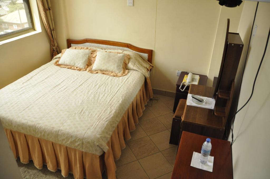 Postel nebo postele na pokoji v ubytování Rich Hotel