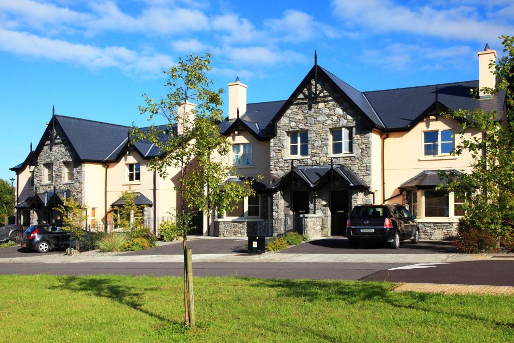 a large house with a car parked in front of it at Ardmullen Walnut 3 Bed Holiday Home in Kenmare