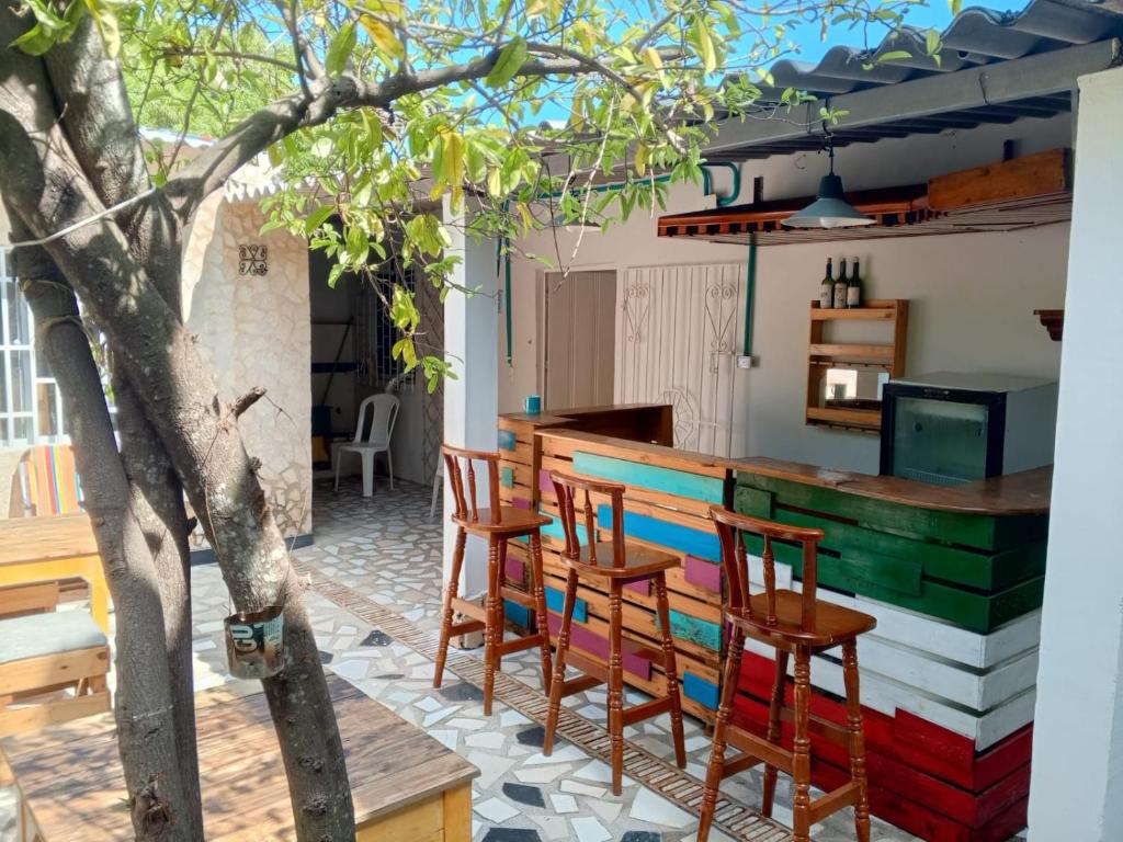 a kitchen with a colorful bar with wooden chairs at Habitaciones independientes con baño privado #6 in Cartagena de Indias