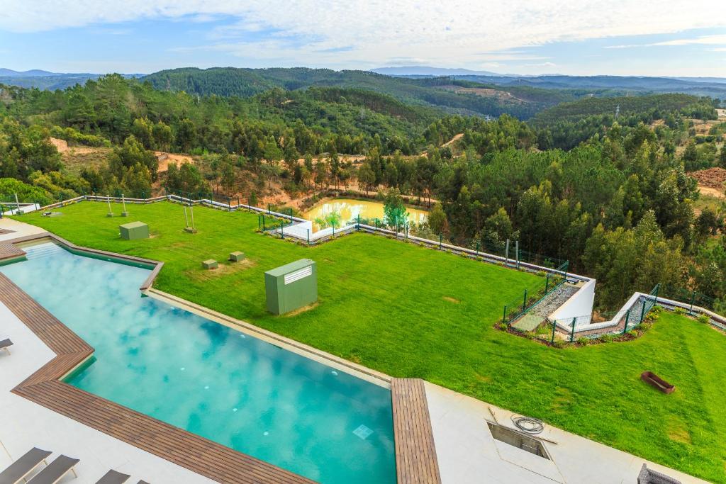 an aerial view of a large yard with a swimming pool at Enigma - Nature & Water Hotel in São Teotónio