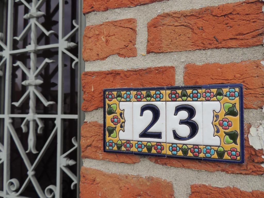 um sinal no lado de uma parede de tijolos em B&B Stoega em Bruges