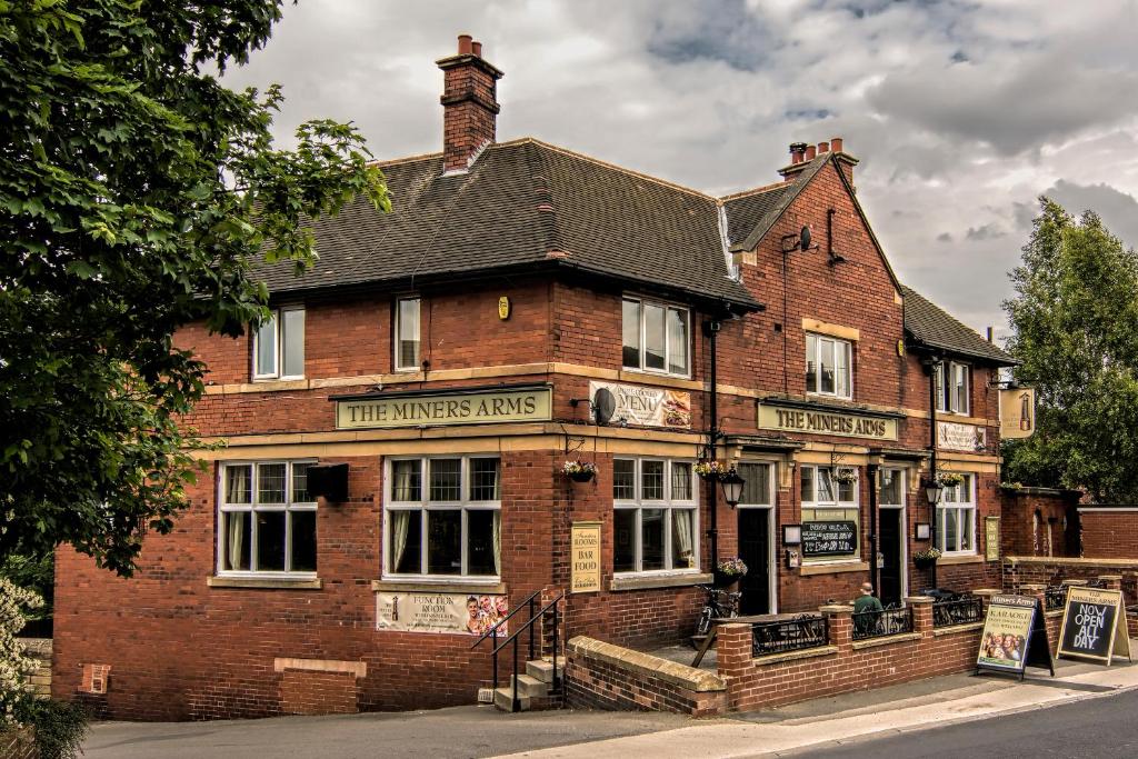 an old brick building on the corner of a street at The Miners Arms in Leeds