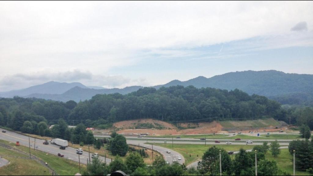 a view of a highway with mountains in the background at Days Inn by Wyndham Waynesville NC in Waynesville