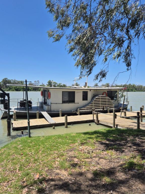 a boat is docked at a dock on the water at Paddle Wheeler Lilian in Mannum