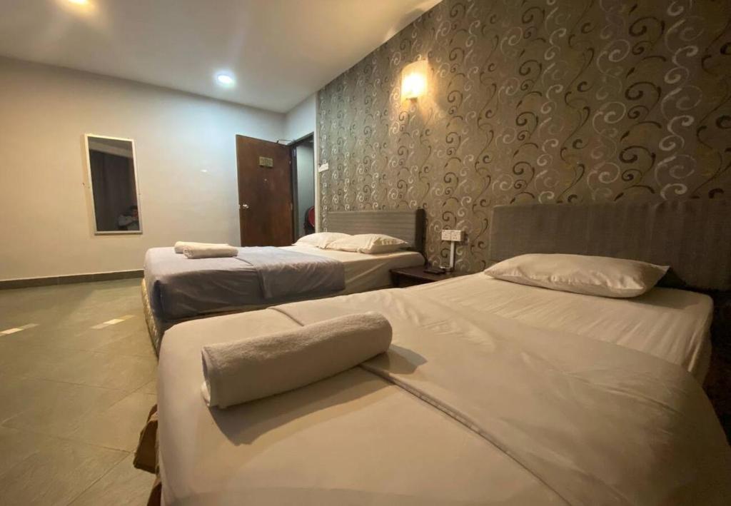Postel nebo postele na pokoji v ubytování Hotel Harbour Inn