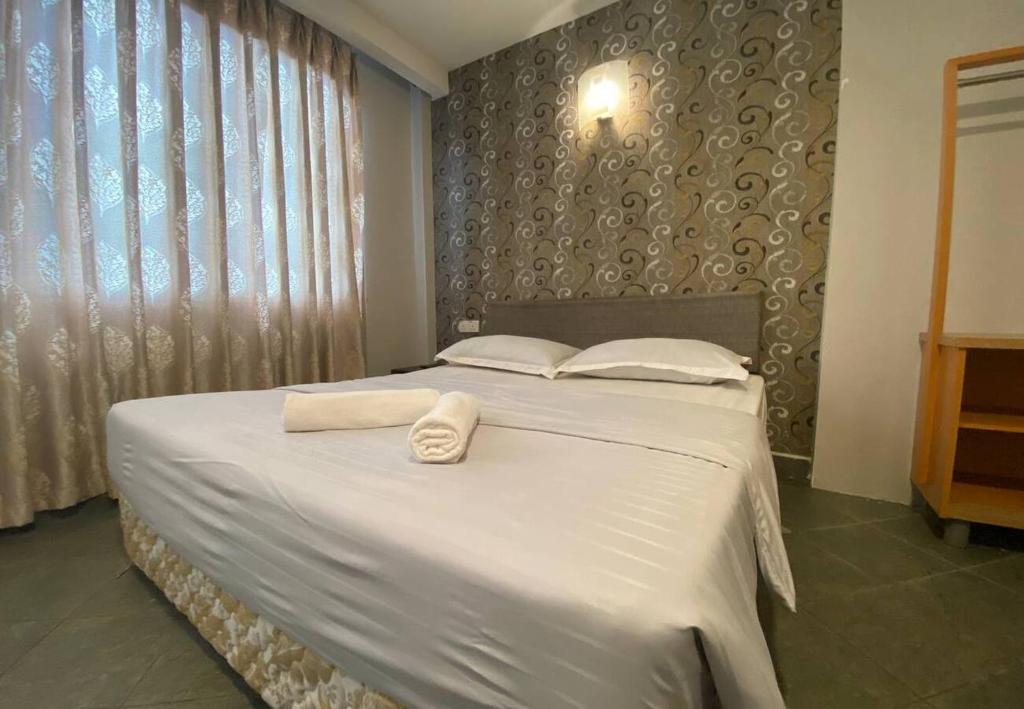 Postel nebo postele na pokoji v ubytování Hotel Harbour Inn