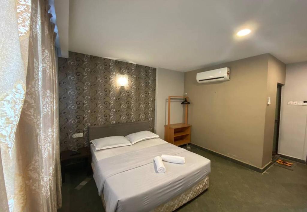 Postel nebo postele na pokoji v ubytování Hotel Harbour Inn