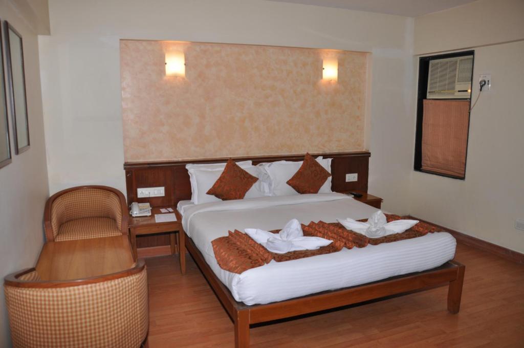 Postel nebo postele na pokoji v ubytování Hotel Abigail Regency