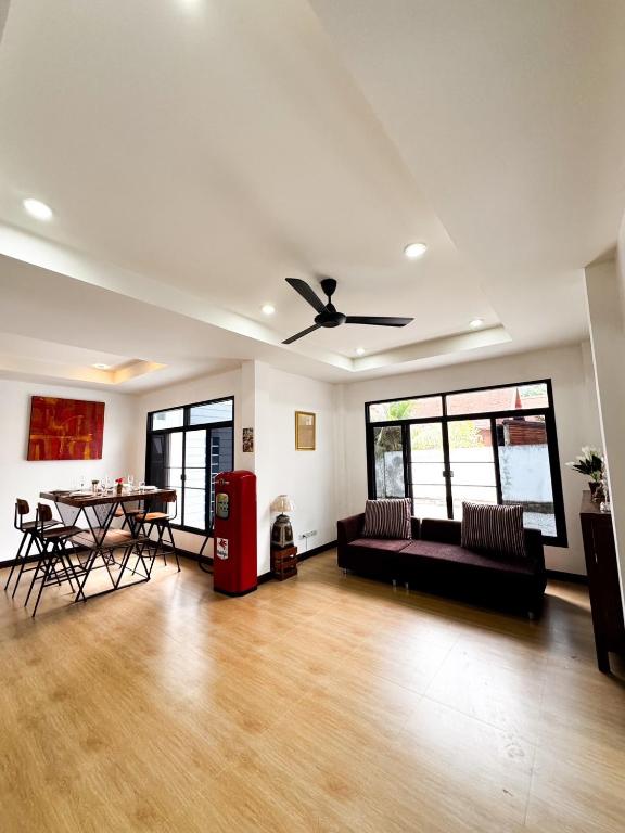 a living room with a couch and a table at villa kitty in Ban Thung Satong