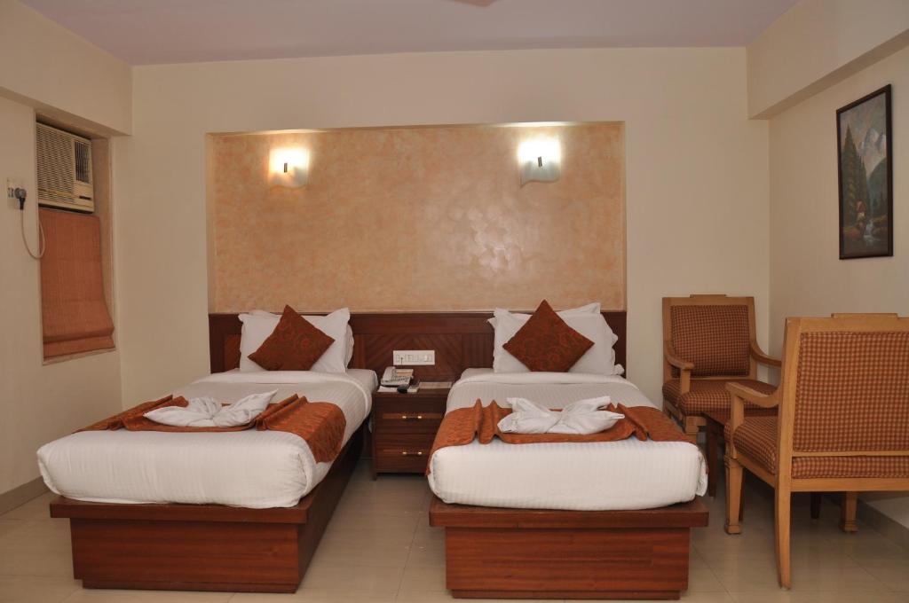 Postel nebo postele na pokoji v ubytování Hotel Abigail Regency