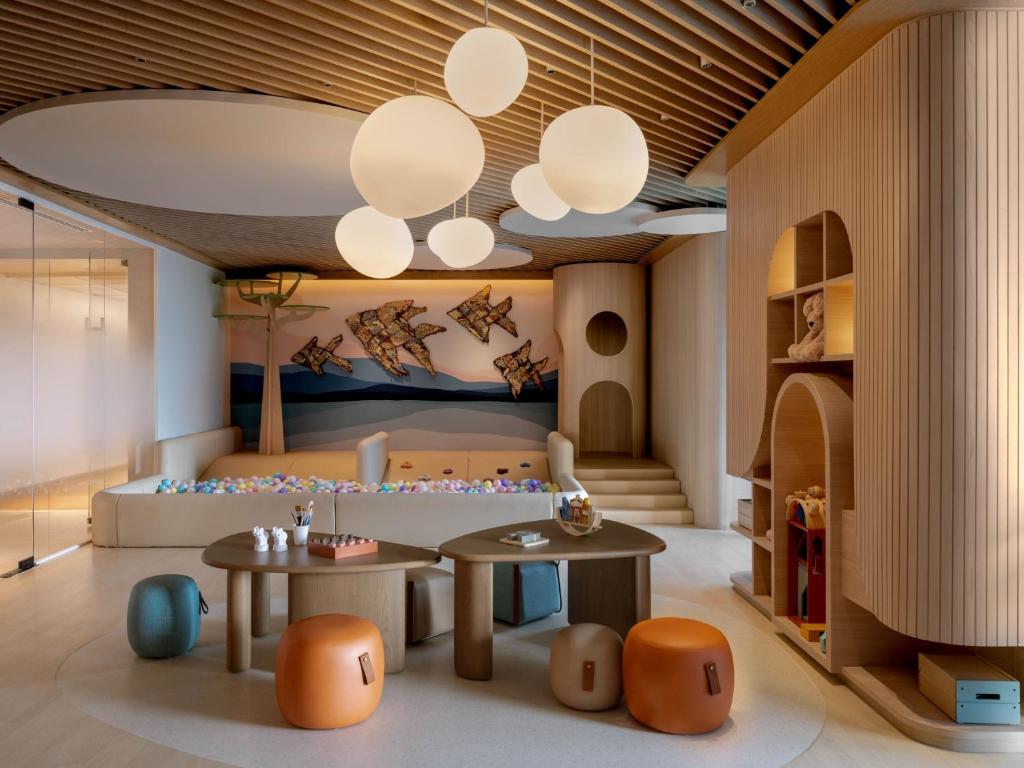 a childrens room with two tables and a bed at Dusit Thani Bangkok in Bangkok