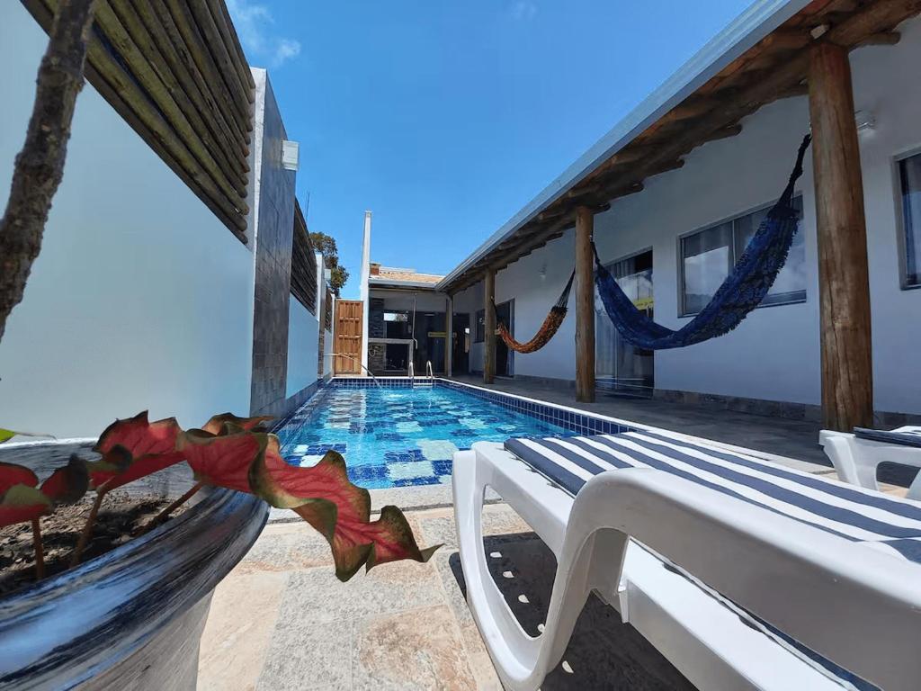 a villa with a swimming pool next to a house at Casa Lua in Prado