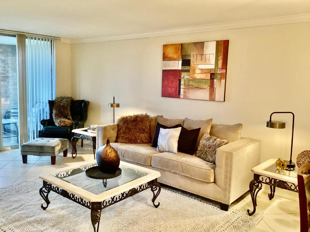 a living room with a couch and a table at Medical Center Rice Village Condo in Houston
