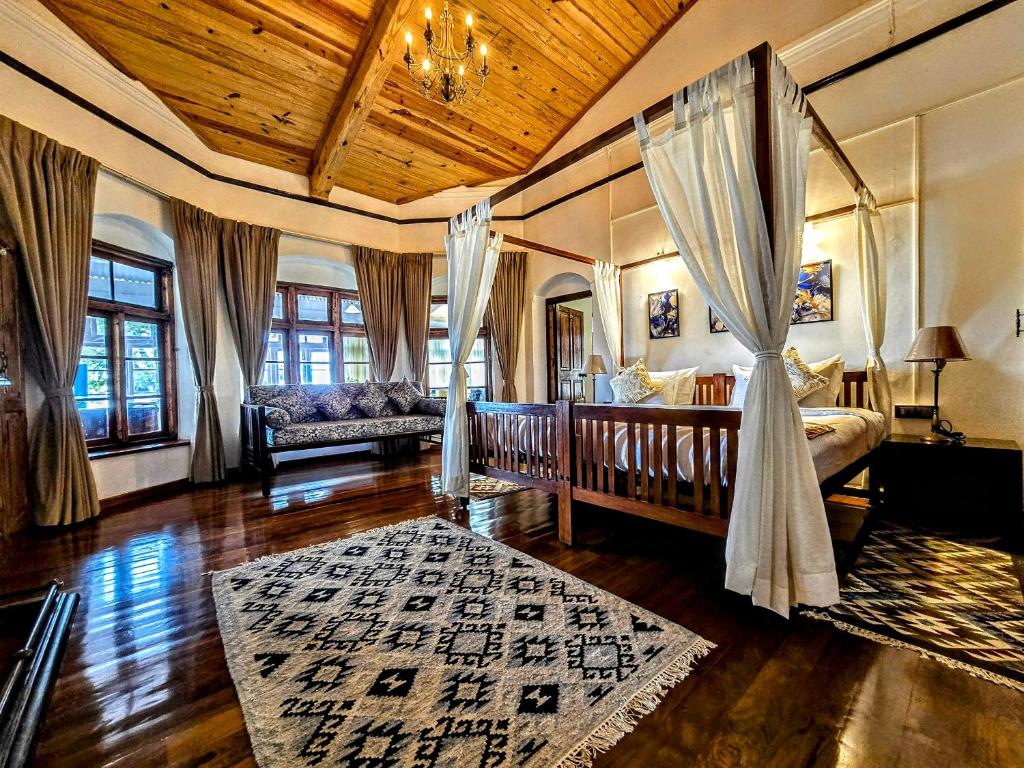 a living room with a bed and a couch at Milhaven Crest in Kodaikānāl