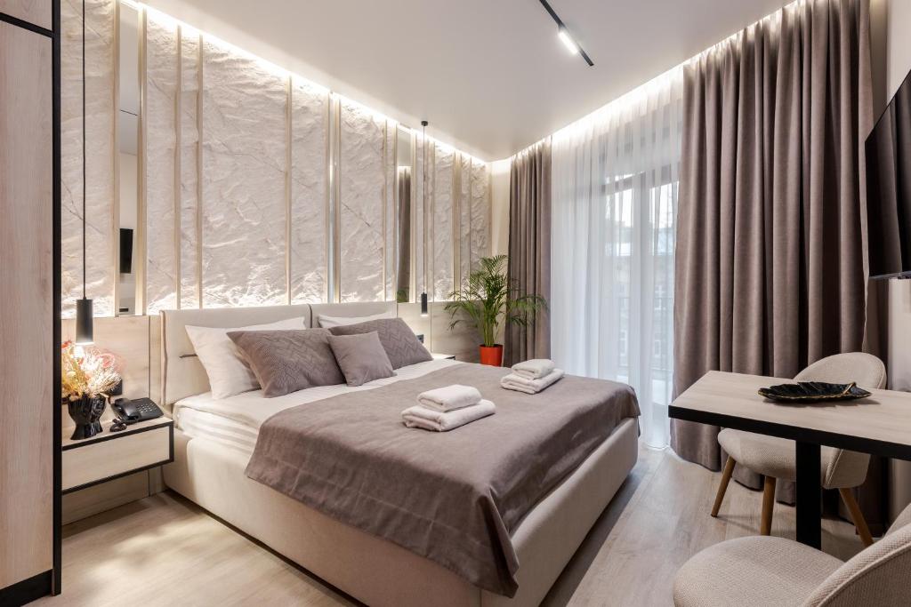 Postel nebo postele na pokoji v ubytování ACCENT Apart-Hotel