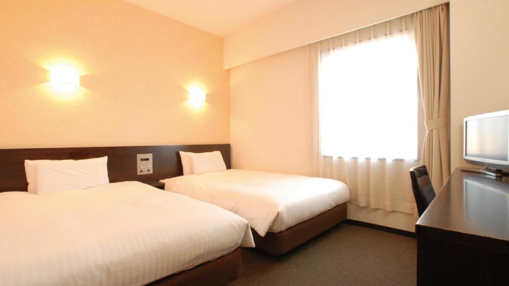 Postel nebo postele na pokoji v ubytování AB Hotel Mikawa Anjo Shinkan