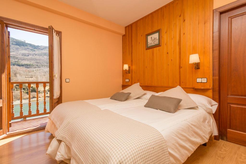 Postel nebo postele na pokoji v ubytování Hostal Casa Rosita