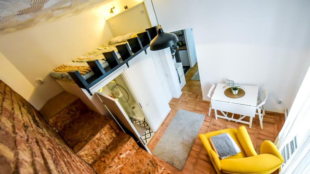 an overhead view of a living room with yellow furniture at Architectural Gem with Modern Flair - Double Studio Old Town in Bucharest