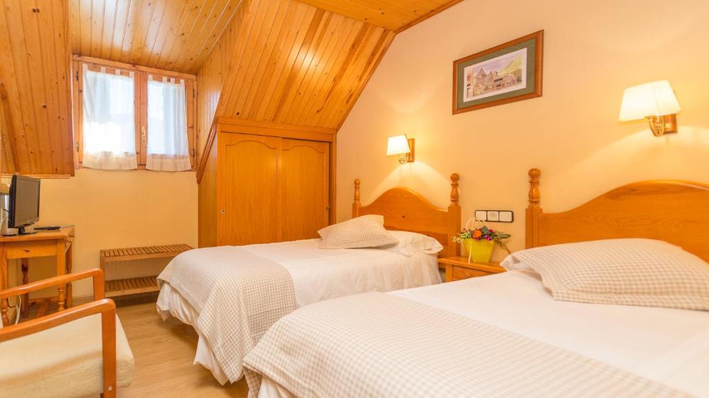 Postel nebo postele na pokoji v ubytování Hostal Casa Rosita