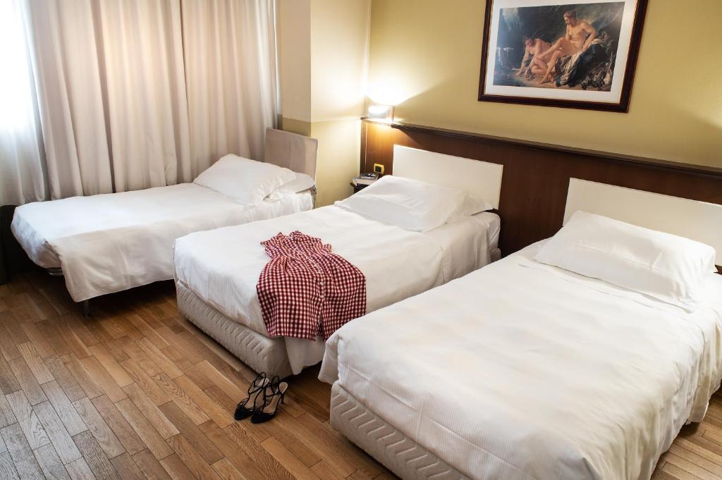 Postel nebo postele na pokoji v ubytování Hotel Alga