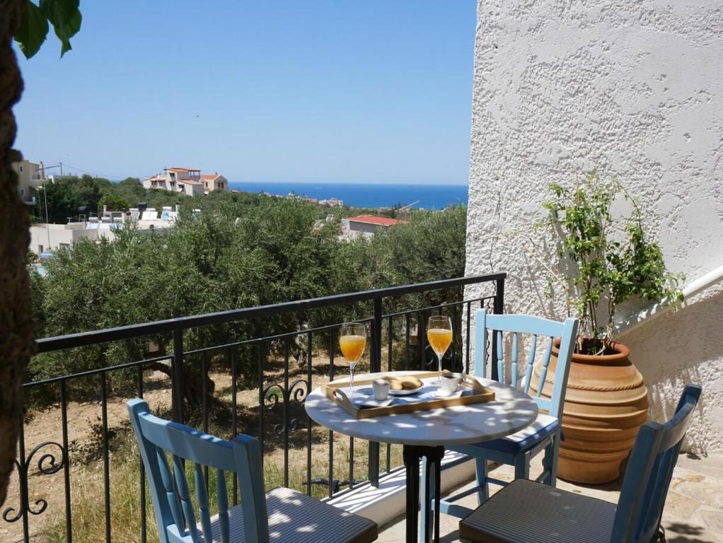 a table and chairs on a balcony with a view of the ocean at Christina's Villa with sea view in Daratso