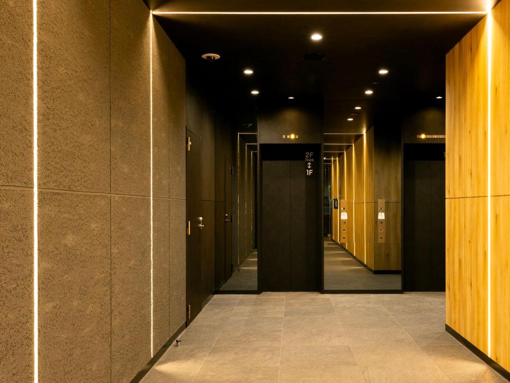 a hallway of a building with a row of doors at SUPER HOTEL Ikebukuro West Natural Hot Spring in Tokyo