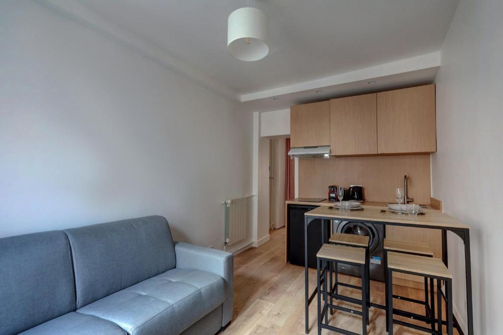 un salon avec un canapé et une cuisine dans l'établissement Bluestay 850 - Superb apartment, à Paris