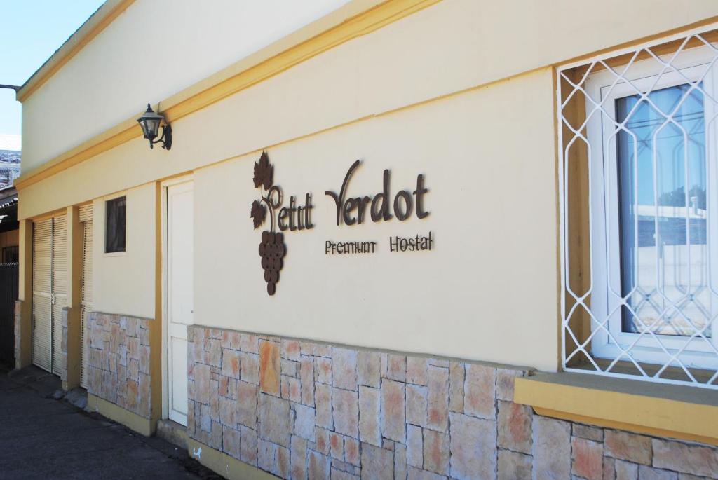 a building with a sign on the side of it at Hostal Petit Verdot in Santa Cruz