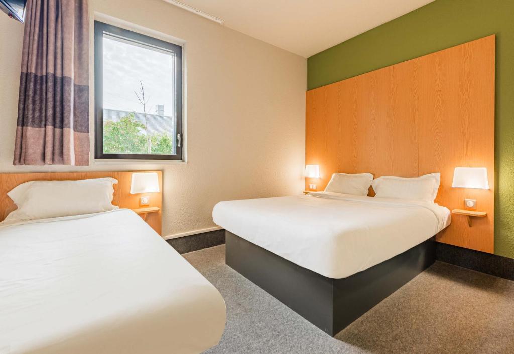 Postel nebo postele na pokoji v ubytování B&B HOTEL Colmar Expo