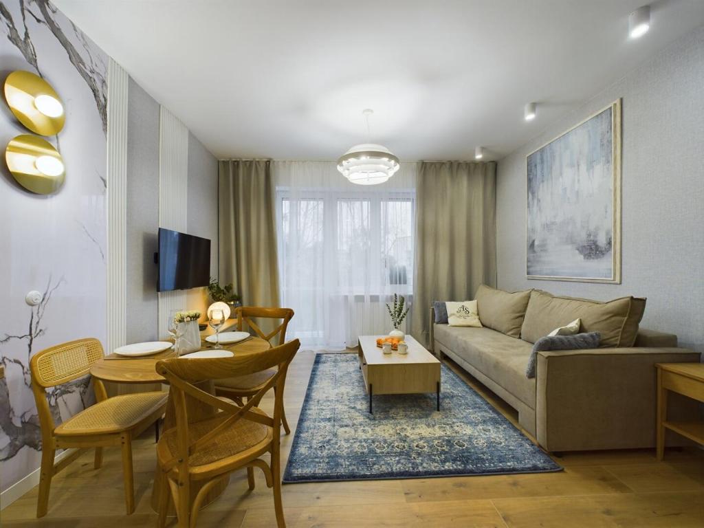 a living room with a couch and a table at ApartamentuSnu, Sportowa I in Radom